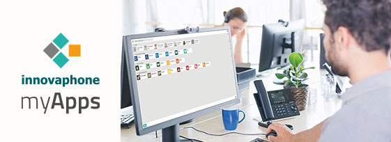 Kollegen sitzen an ihrem Arbeitsplatz, myApps ist auf dem Bildschirm geöffnet 